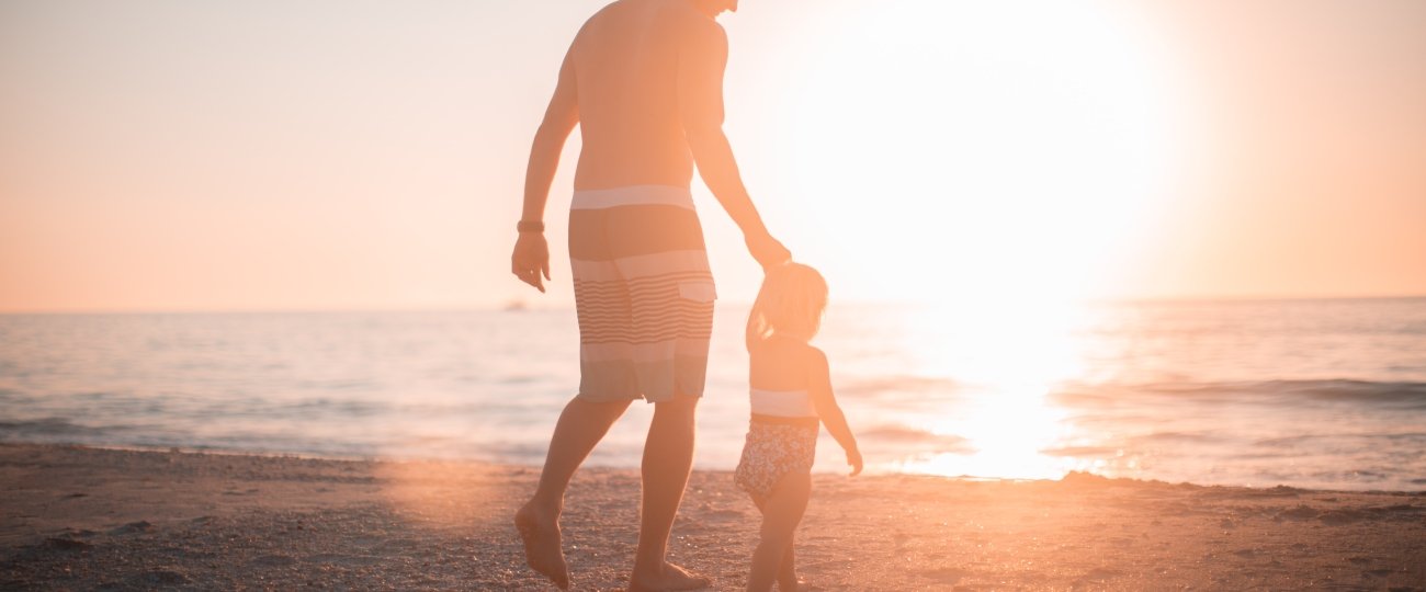 Father and son on beach together