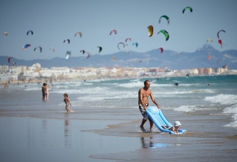 Family on beach, in Spain on villa holiday.