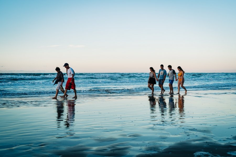 Family and friends on beach, Italy