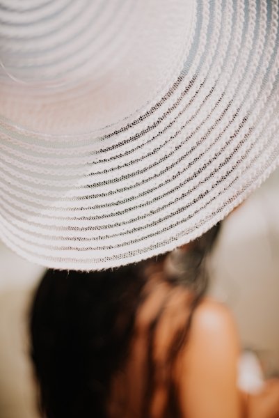 Lady on beach with large sun hat