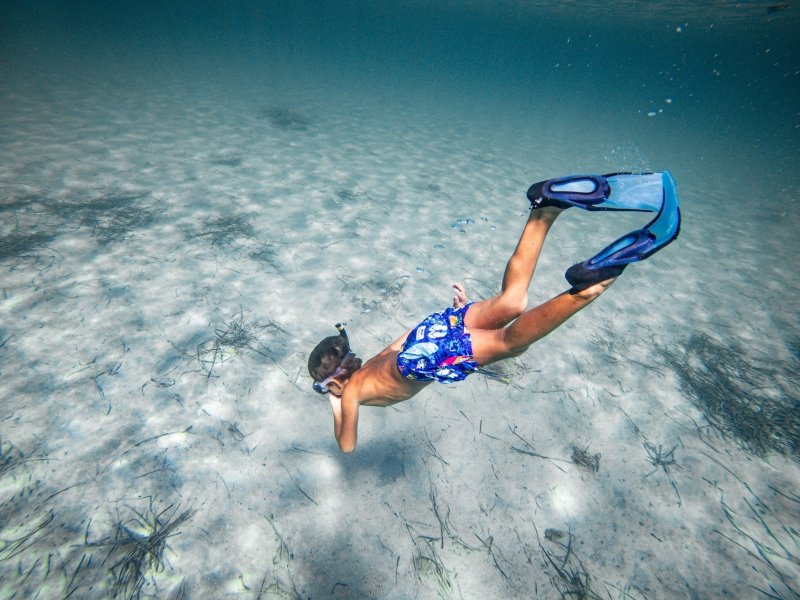 Boy snorkelling underwater, Sardinia